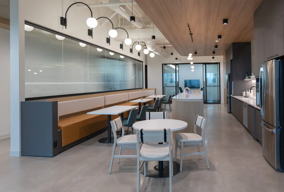 Café and breakout space with wood ceiling accent
